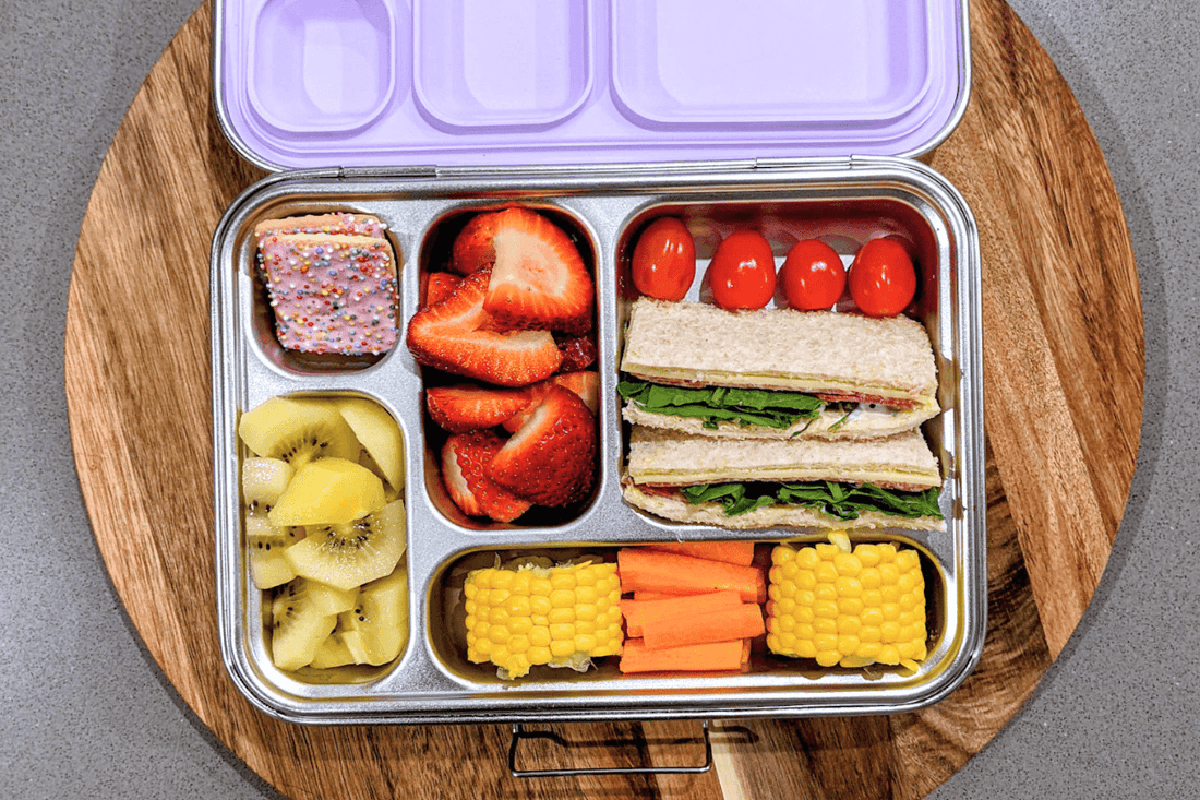Lunchbox with sandwich, fruits, vegetables and sweet treat
