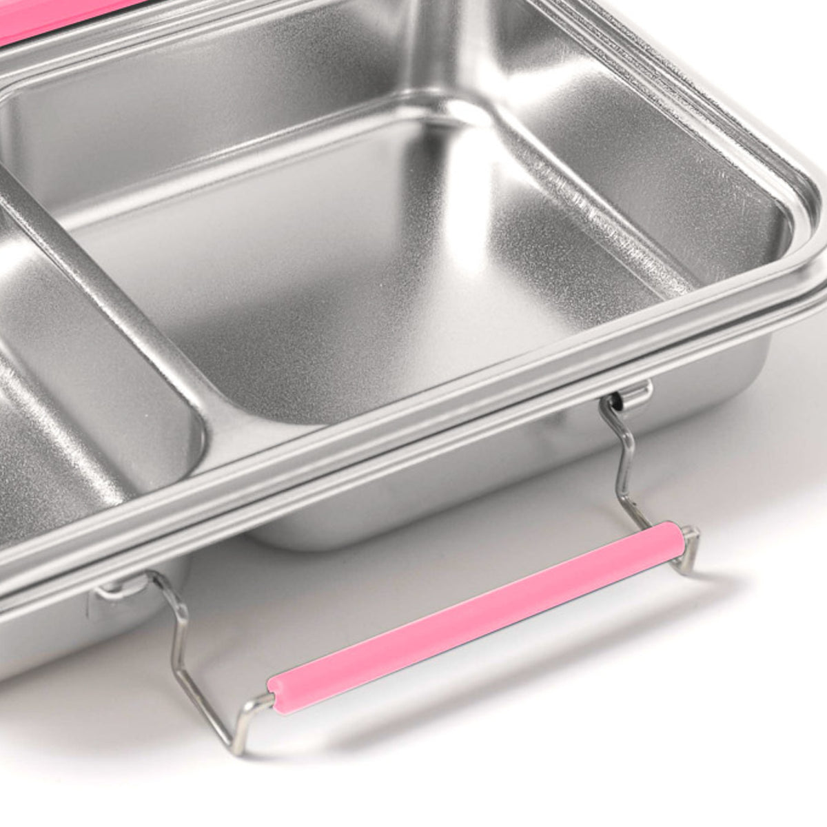 Pink silicone replacement latch fitted to the side of a stainless steel bento box