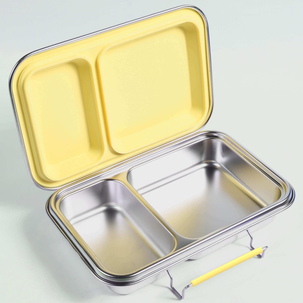 Open two-compartment stainless steel bento box with a yellow lid and matching yellow latch