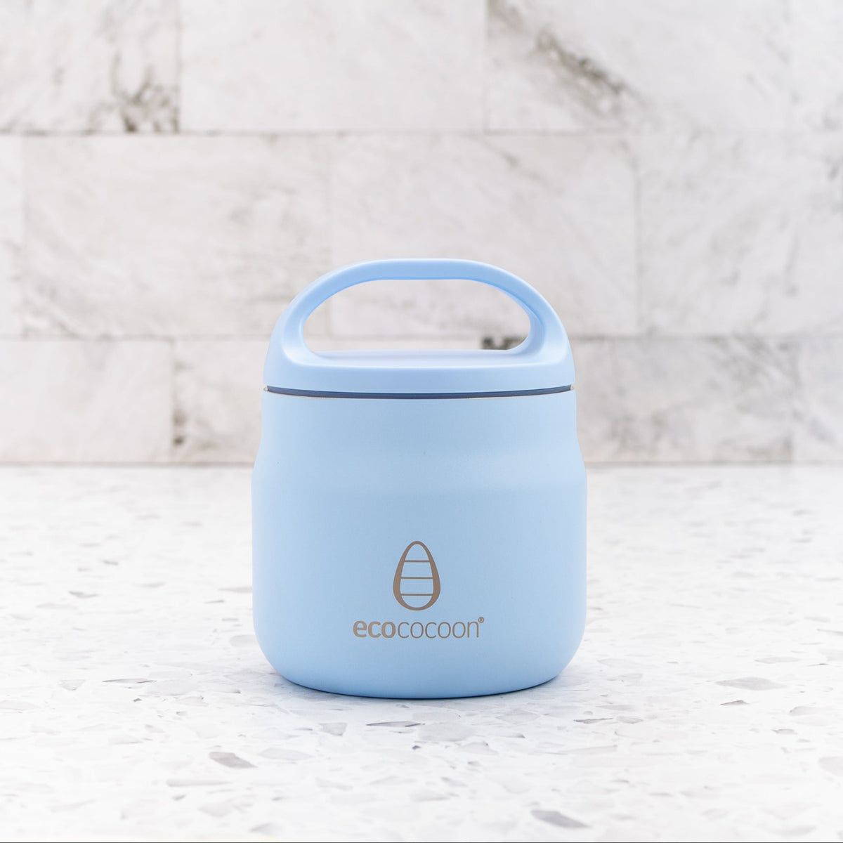 Light blue thermos with handle on a marble background