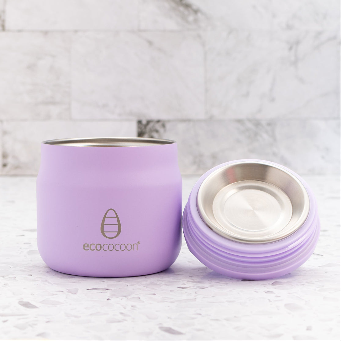 Purple insulated tumbler with a silver lid on a marble surface