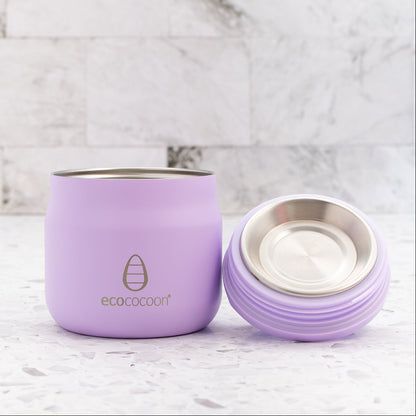 Purple insulated tumbler with a silver lid on a marble surface