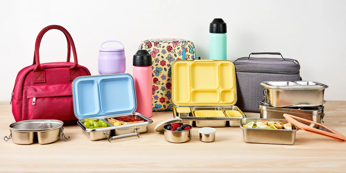 colourful stainless steel lunch wear and lunch bags in a studio setting