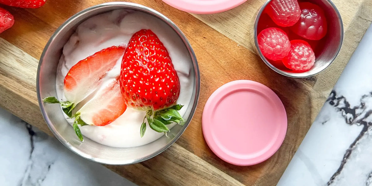 pink snack container with yoghurt and strawberries